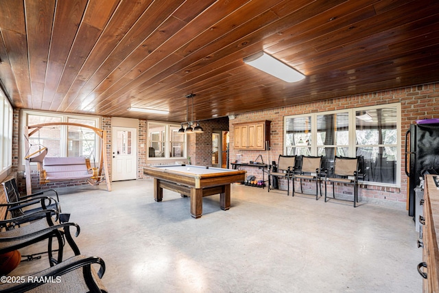 rec room featuring brick wall, concrete floors, billiards, and wood ceiling