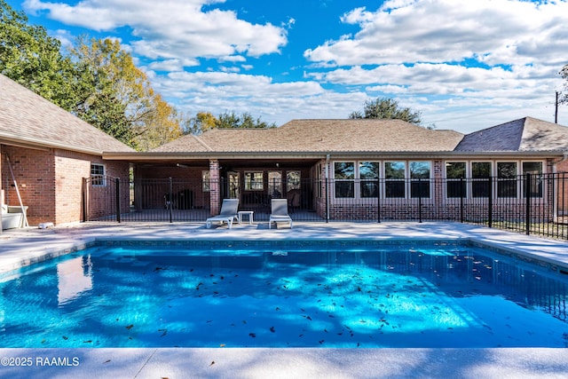 view of swimming pool featuring a patio area, fence, and a fenced in pool