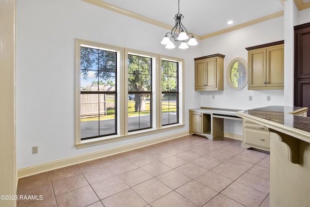 kitchen featuring hanging light fixtures, light tile patterned floors, ornamental molding, and an inviting chandelier