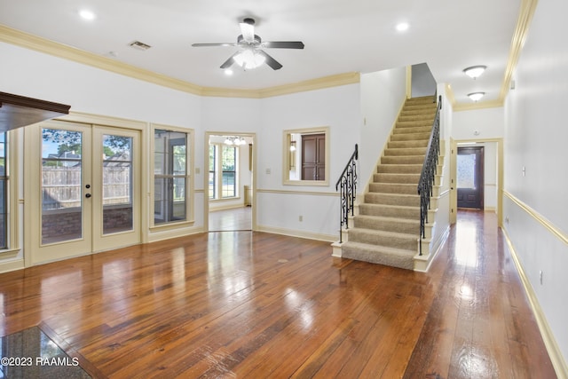 unfurnished living room with ceiling fan, crown molding, and french doors