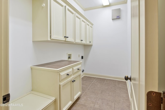 laundry area featuring light tile patterned floors, electric dryer hookup, hookup for a washing machine, cabinets, and ornamental molding