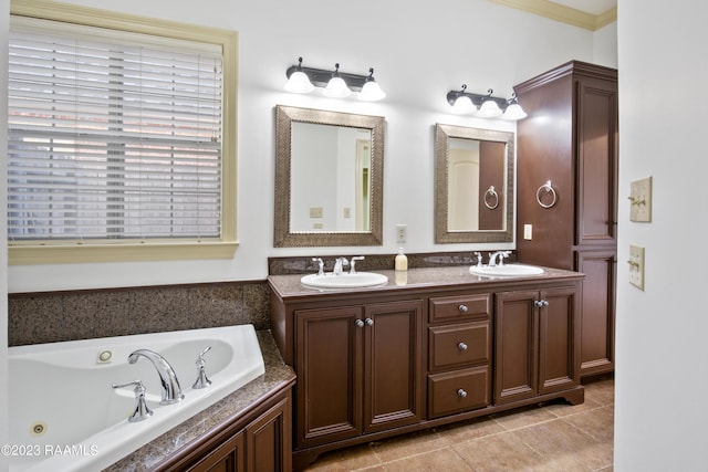 bathroom with a tub to relax in, vanity, and tile patterned floors