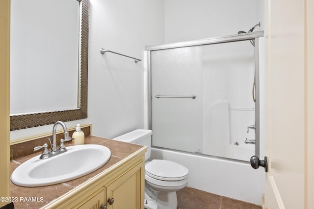 full bathroom with toilet, enclosed tub / shower combo, tile patterned floors, and vanity