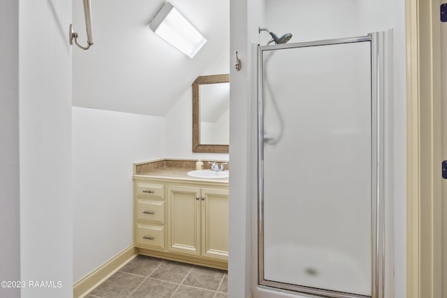 bathroom featuring a shower with shower door, tile patterned floors, vanity, and lofted ceiling