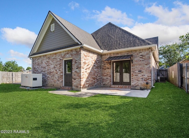 back of property with central AC, french doors, a lawn, and a patio