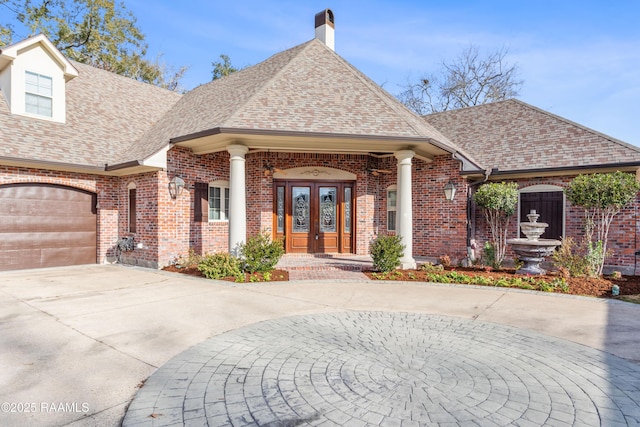 view of front of property with a garage and french doors