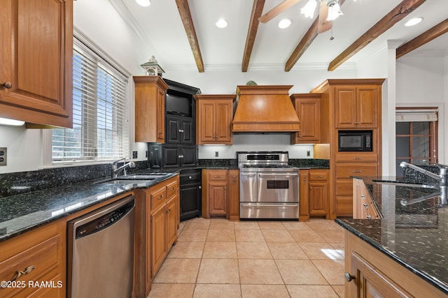 kitchen featuring premium range hood, stainless steel appliances, sink, and dark stone countertops