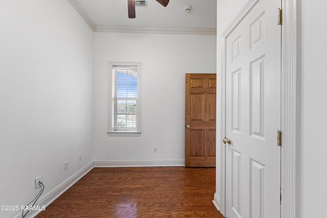 empty room with ornamental molding, dark hardwood / wood-style floors, and ceiling fan