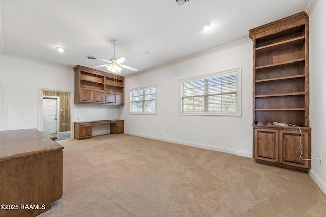 unfurnished office featuring light carpet, built in desk, and ornamental molding