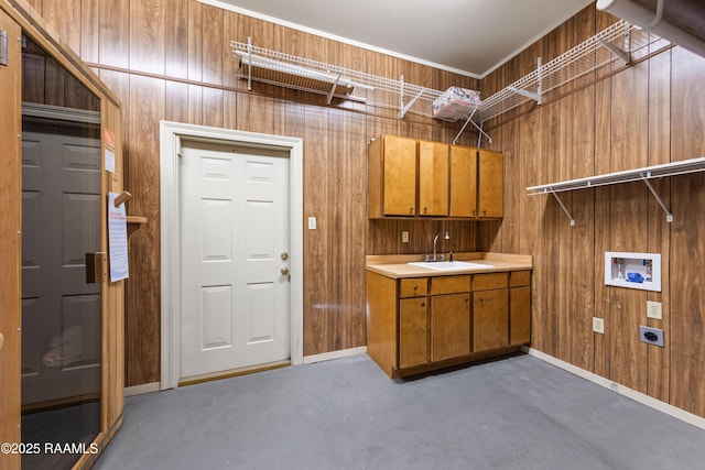 laundry room featuring sink, wood walls, cabinets, hookup for a washing machine, and electric dryer hookup