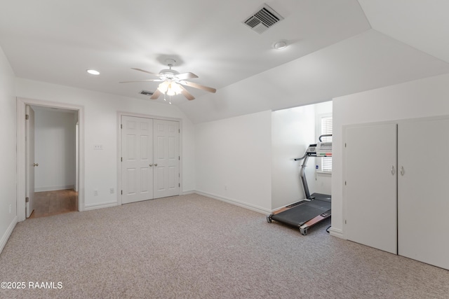 interior space featuring ceiling fan, lofted ceiling, and light carpet