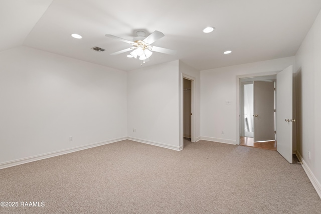 spare room featuring ceiling fan and light carpet