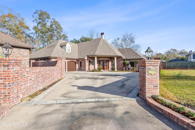 view of front of home with a garage and a front yard