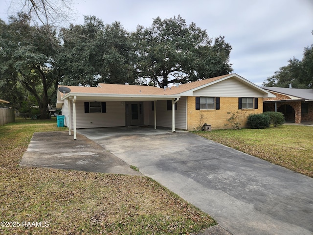 ranch-style house with a front yard and a carport