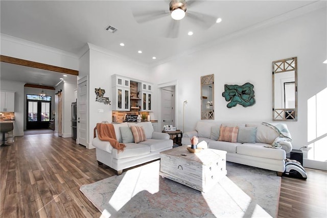 living room with a wealth of natural light, recessed lighting, dark wood-style flooring, and crown molding