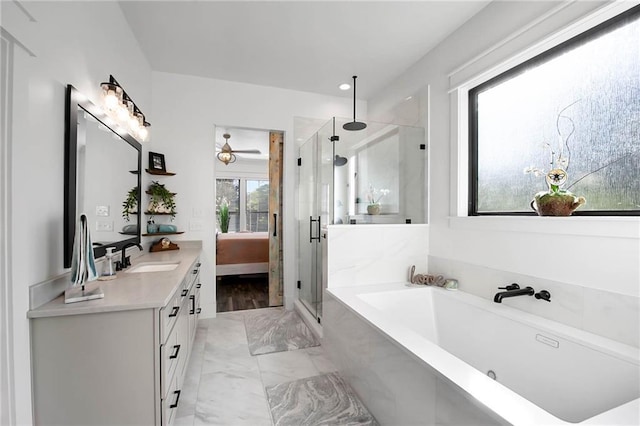 ensuite bathroom with ensuite bathroom, vanity, marble finish floor, a tub, and a stall shower