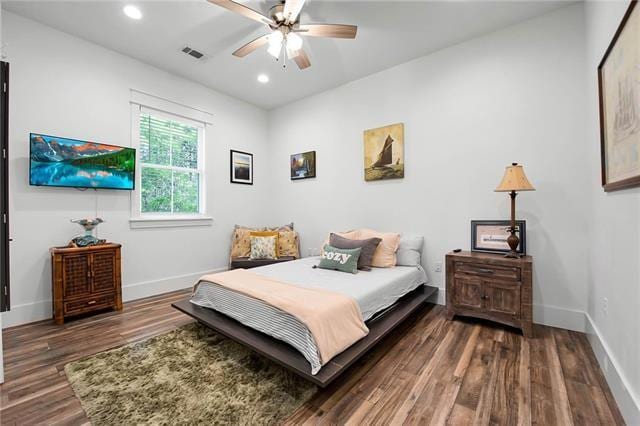 bedroom with recessed lighting, visible vents, baseboards, and wood finished floors