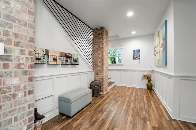 interior space with a wainscoted wall, a decorative wall, wood finished floors, and recessed lighting