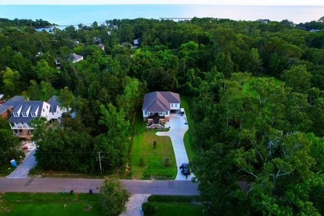 drone / aerial view with a wooded view