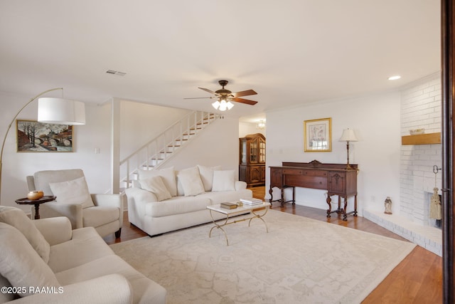 living room featuring ceiling fan, crown molding, and hardwood / wood-style floors