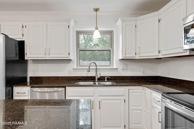 kitchen with appliances with stainless steel finishes, pendant lighting, white cabinetry, and sink