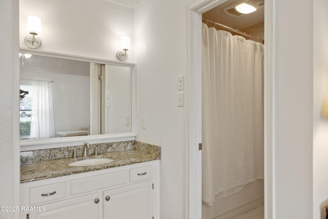 full bathroom with toilet, vanity, and shower / tub combo