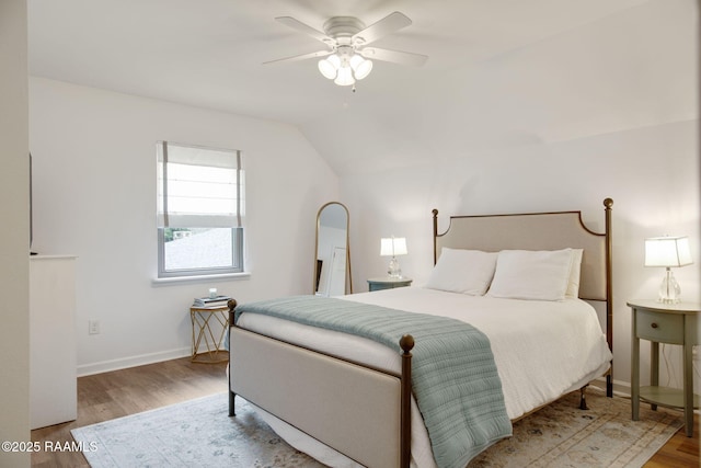 bedroom featuring vaulted ceiling, ceiling fan, and hardwood / wood-style floors