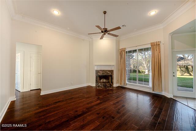 unfurnished living room with a fireplace, dark wood-type flooring, ceiling fan, and crown molding