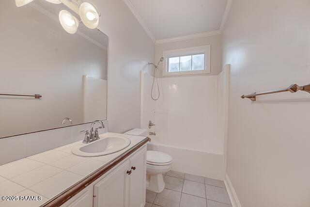 full bathroom featuring tile patterned floors, vanity, shower / washtub combination, toilet, and ornamental molding