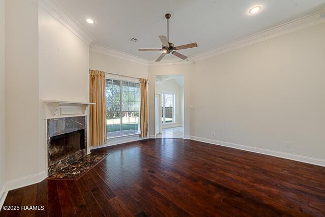 unfurnished living room featuring ceiling fan, wood-type flooring, crown molding, and a premium fireplace