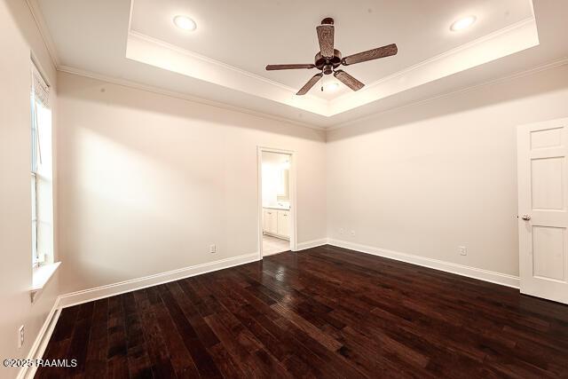 unfurnished room with ceiling fan, hardwood / wood-style flooring, a tray ceiling, and ornamental molding