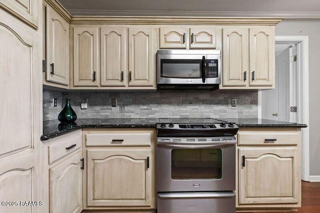 kitchen with tasteful backsplash, stainless steel appliances, light brown cabinetry, and dark stone counters