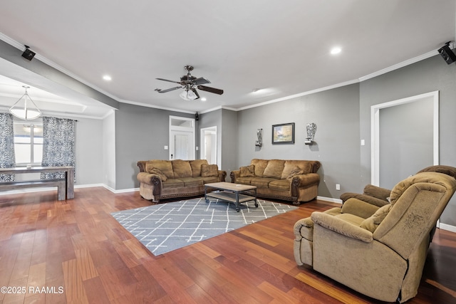 living room featuring wood-type flooring, ornamental molding, and ceiling fan