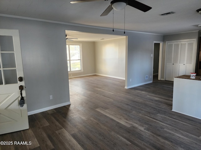 unfurnished living room featuring ceiling fan, ornamental molding, and dark hardwood / wood-style flooring