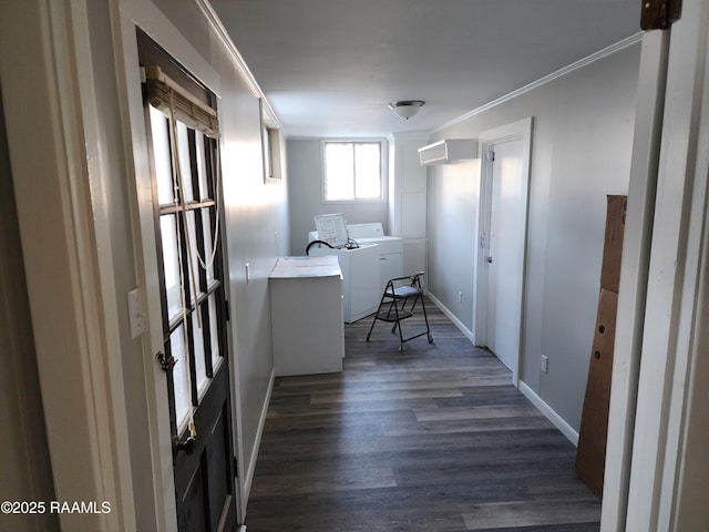 clothes washing area featuring washing machine and clothes dryer, ornamental molding, and dark hardwood / wood-style flooring