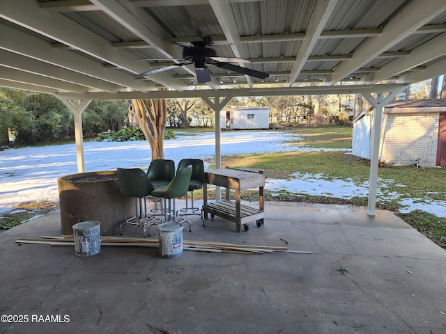 view of patio featuring a storage shed and ceiling fan