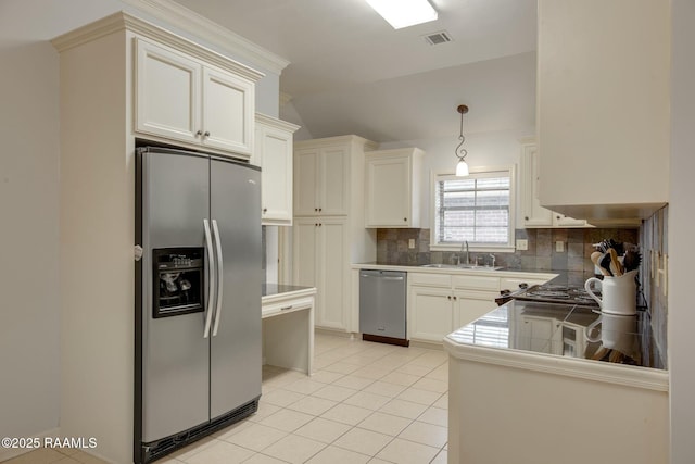 kitchen featuring lofted ceiling, stainless steel appliances, decorative backsplash, sink, and light tile patterned flooring