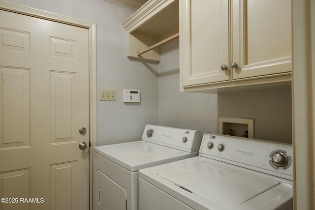 washroom featuring washer and dryer and cabinets