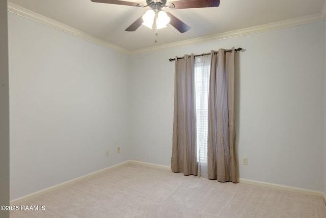 carpeted empty room featuring ceiling fan and ornamental molding