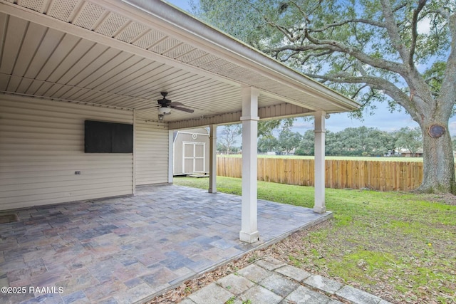 view of patio / terrace featuring ceiling fan and a storage unit