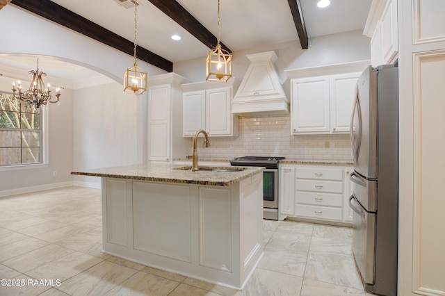 kitchen featuring custom exhaust hood, appliances with stainless steel finishes, a kitchen island with sink, light stone countertops, and white cabinets