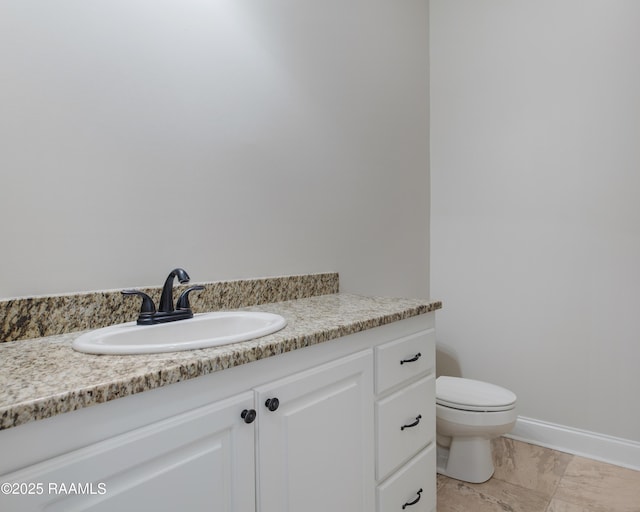 bathroom with toilet and vanity