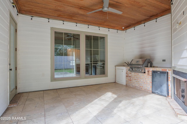 view of patio featuring ceiling fan, a grill, and an outdoor kitchen