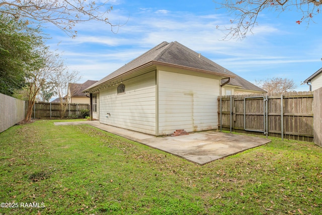 back of house with a patio area and a lawn