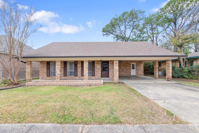 ranch-style house featuring covered porch, a front yard, and a carport