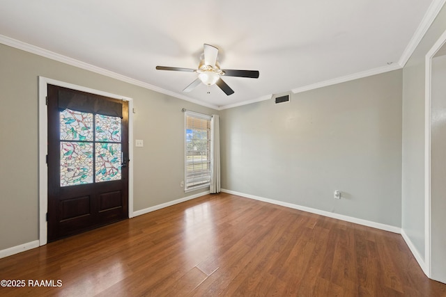 foyer with ceiling fan, a healthy amount of sunlight, crown molding, and dark hardwood / wood-style flooring