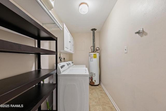 clothes washing area with washer and dryer, cabinets, gas water heater, and light tile patterned flooring