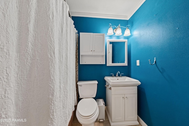 bathroom featuring crown molding, toilet, and vanity