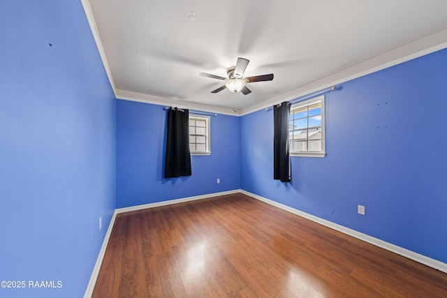 empty room with crown molding, hardwood / wood-style floors, and ceiling fan