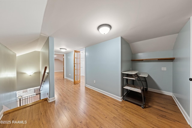 bonus room with light hardwood / wood-style flooring and lofted ceiling